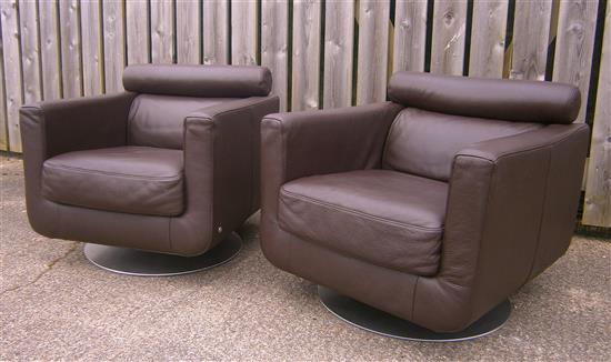 A pair of Natuzzi leather swivel armchairs W.77cm